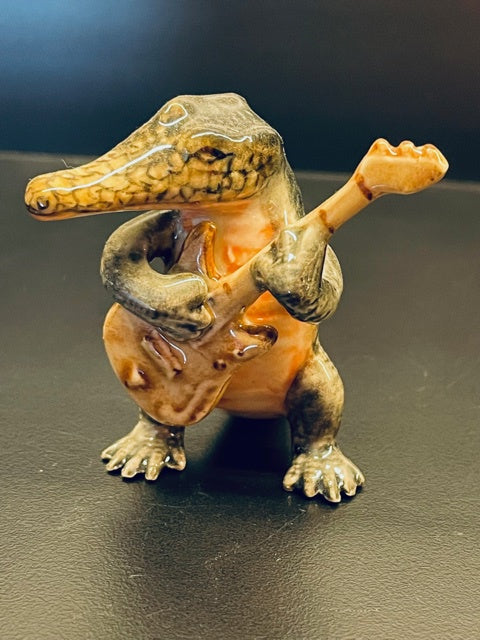 Porcelain Crocodile Playing the Guitar